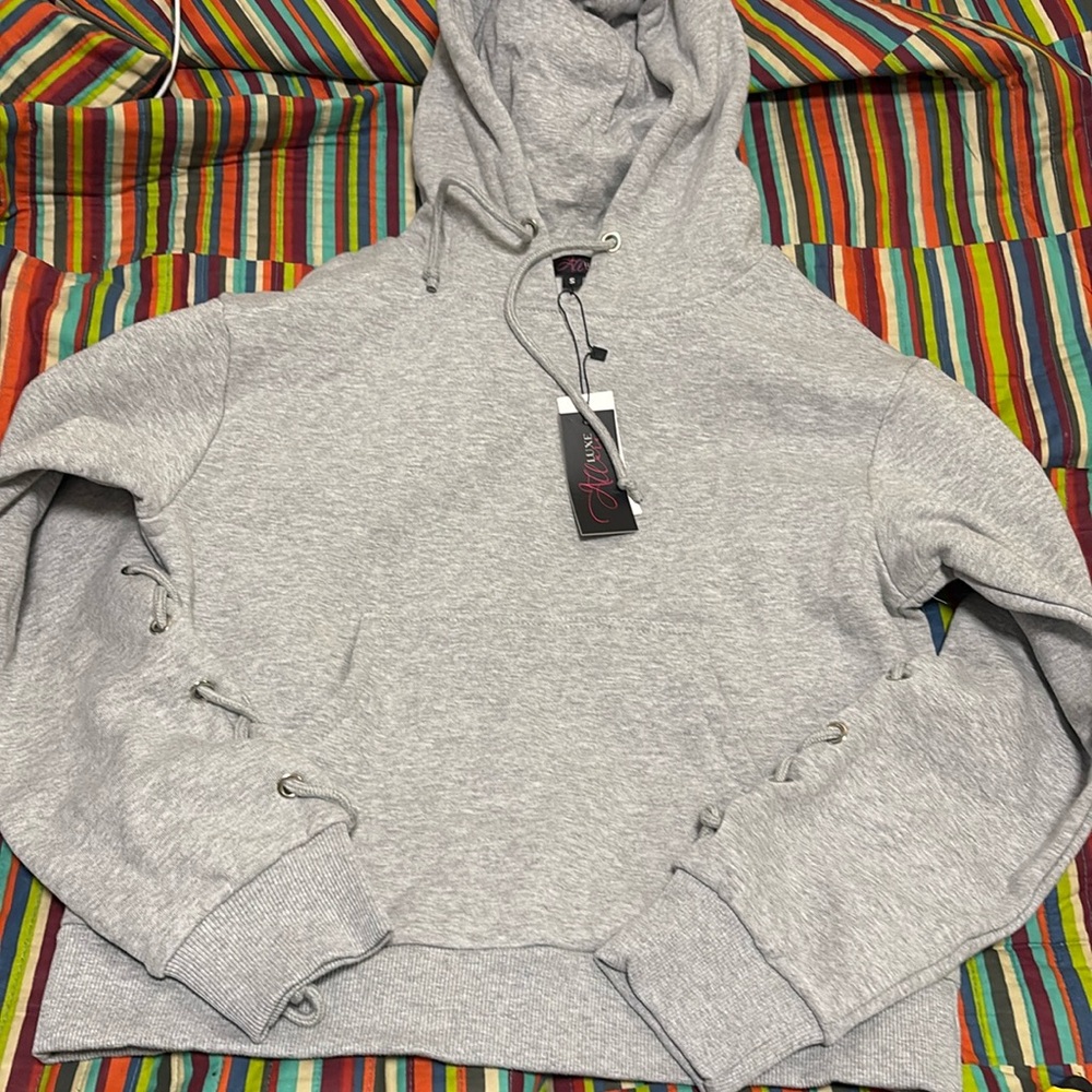 Allure luxe long sleeve hoodie sleeve string detail have a few available small
